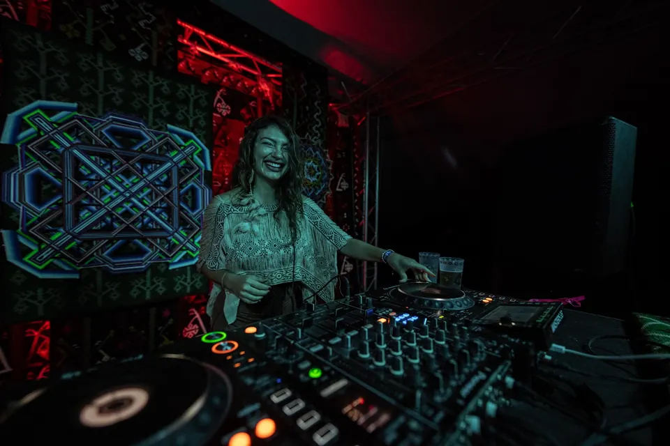 A DJ smiling at the decks on the TOK stage