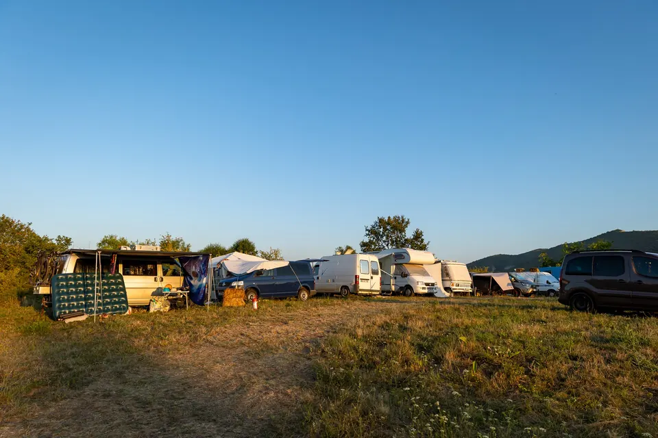 A row of campervans parked in the camper area