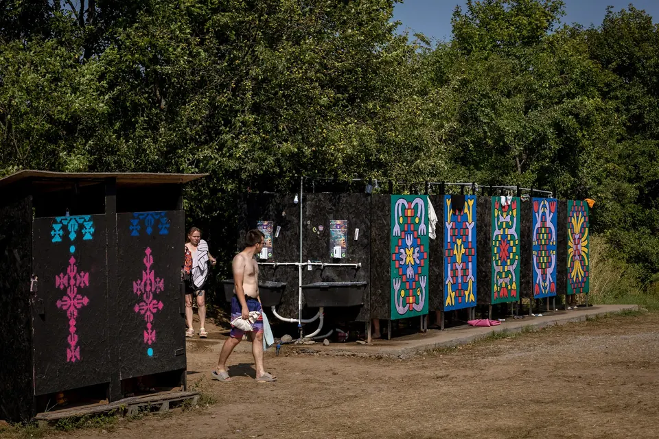 Painted compost toilets at the edge of the forest