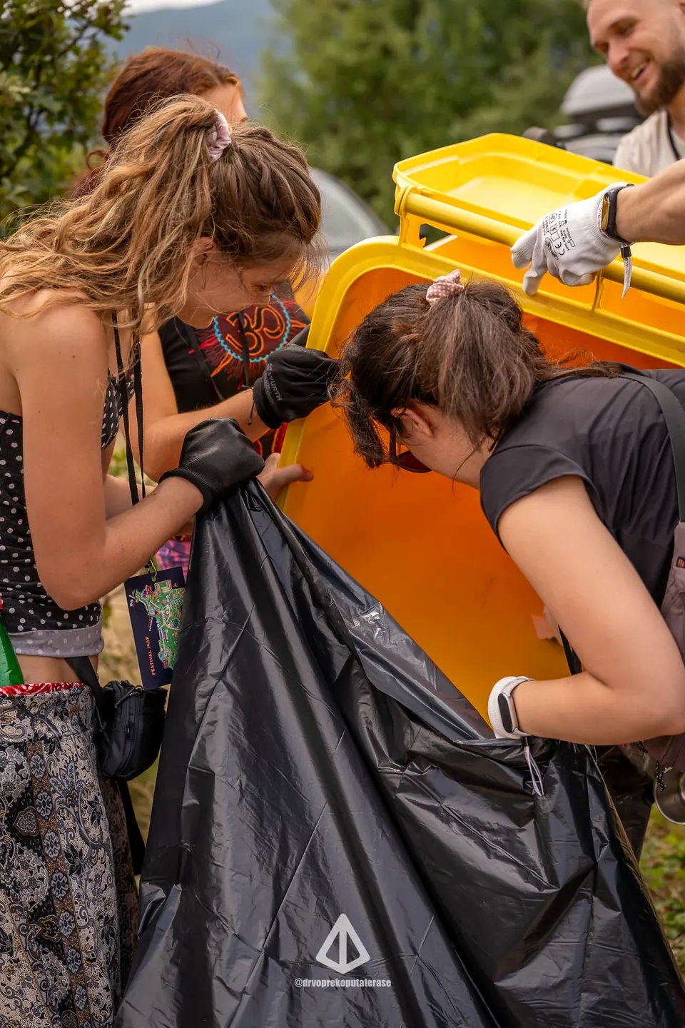 Eco-team volunteers emptying a waste sorting bin