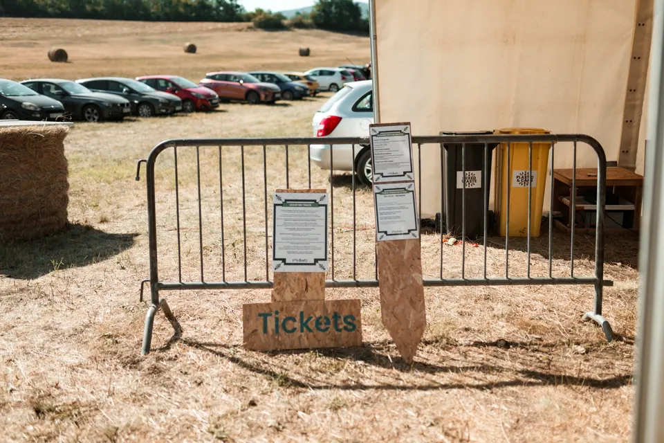 Festival entrance with ticket signs next to the car park