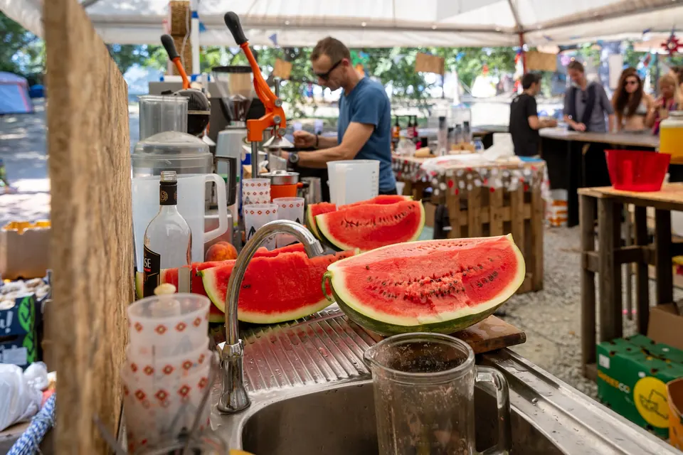 Fresh watermelon being cut at a food court bar