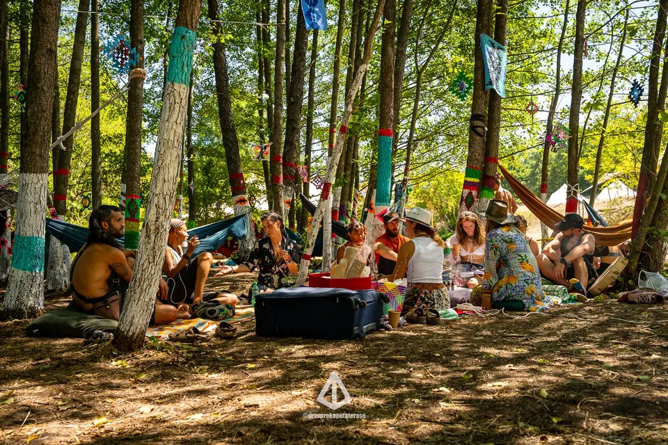 People relaxing on rugs in the forest chill zone