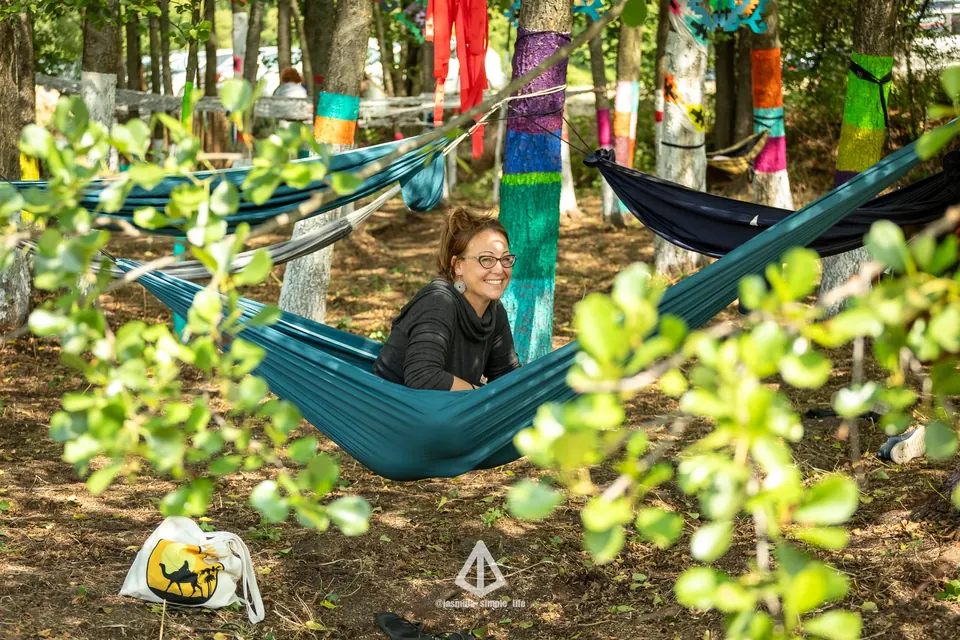 A woman resting in a hammock in the forest shade