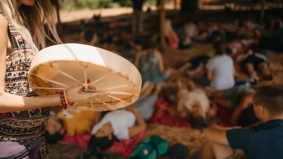 A frame drum played over people lying during a sound journey
