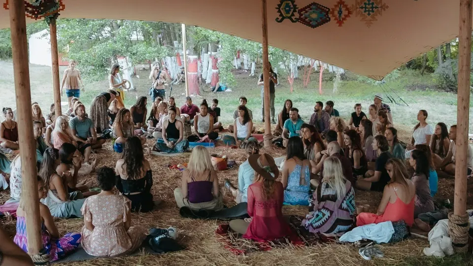 A full circle of participants in the Healing Days tent