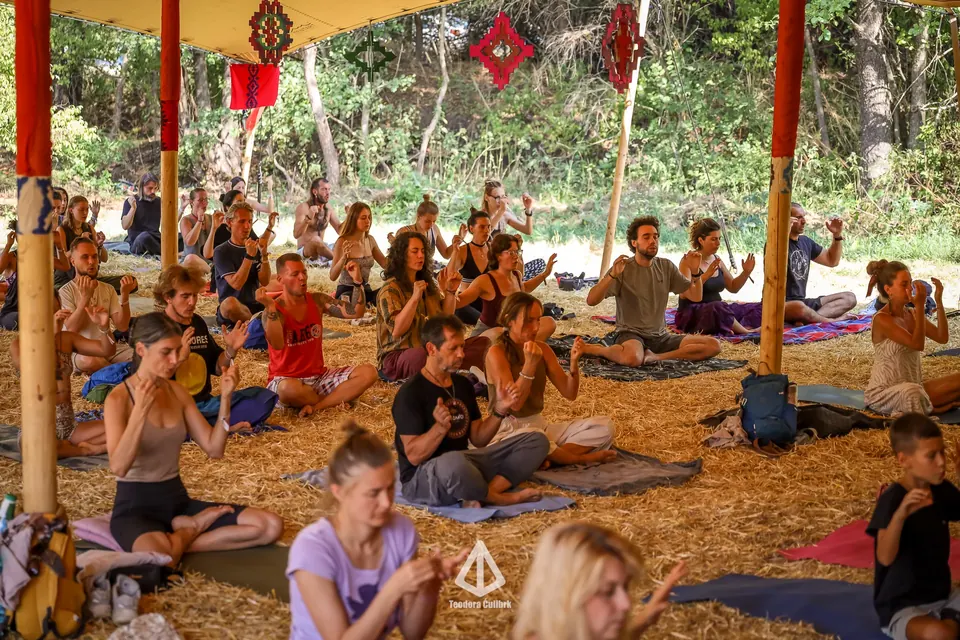 A breathwork session in the healing tent