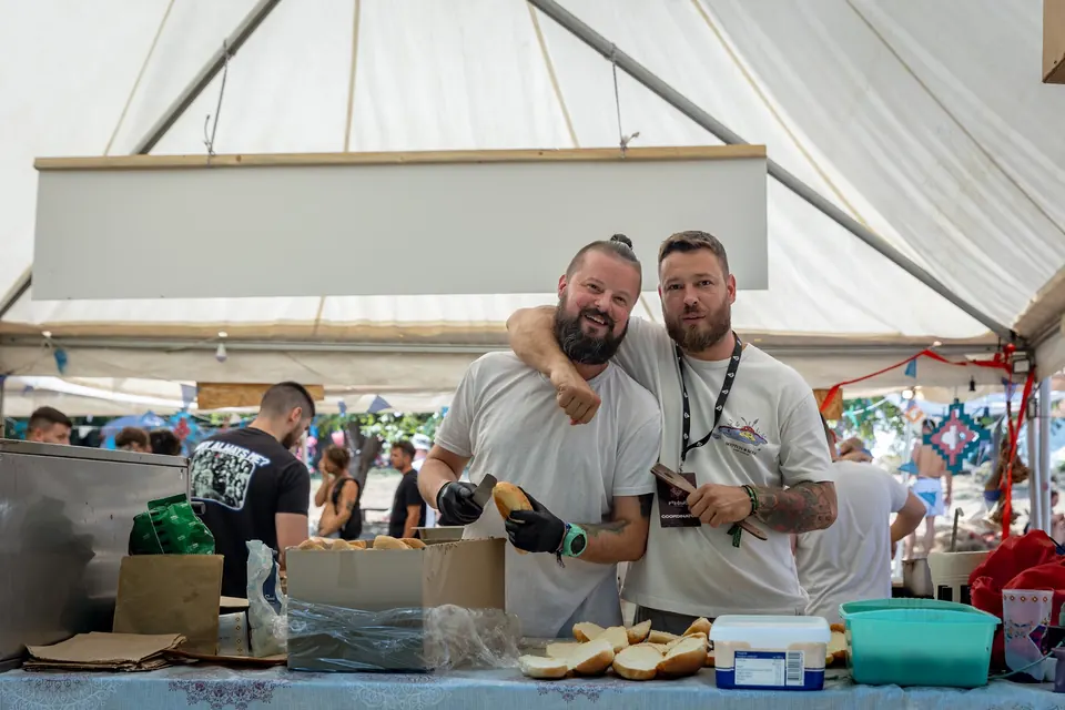 Two crew members smiling in the festival kitchen