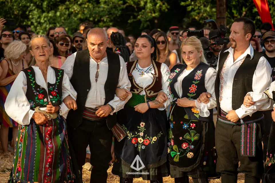 A folk ensemble singing on the meadow