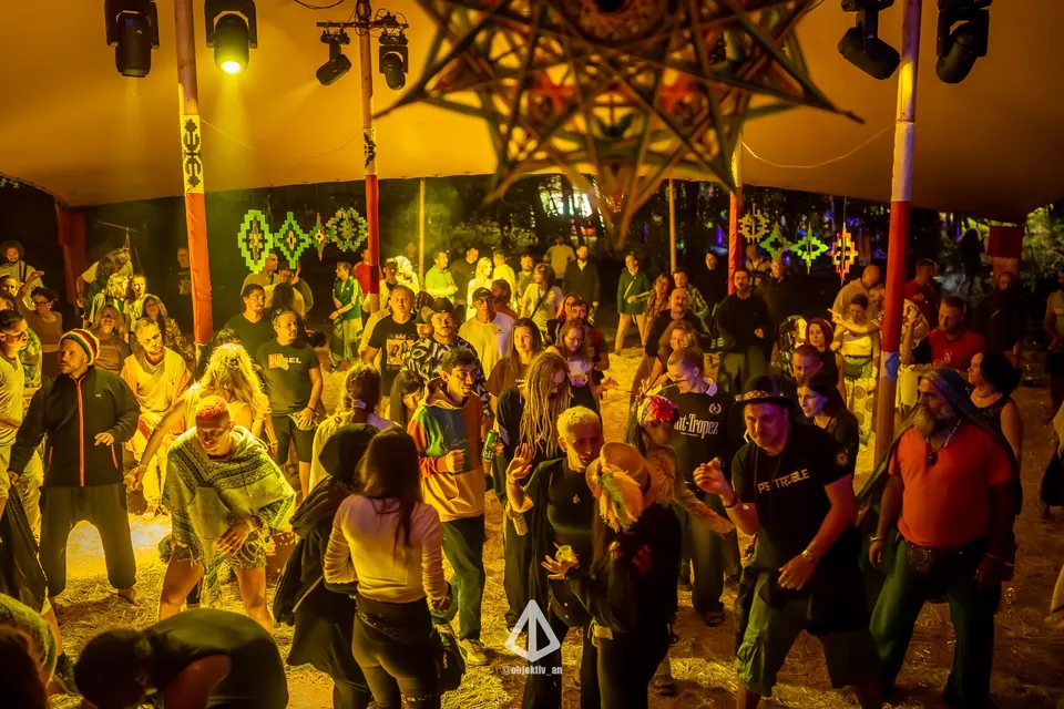 A dancing crowd under warm yellow lights