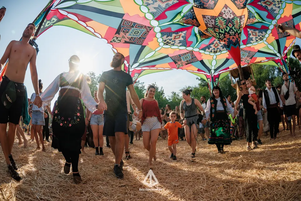 A kolo dance moving under the patterned canopy