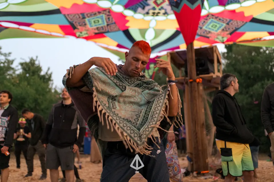 A dancer with a woven scarf on the KOLO dance floor by day
