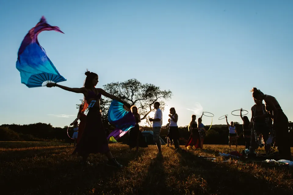 A dancer with silks at sunset