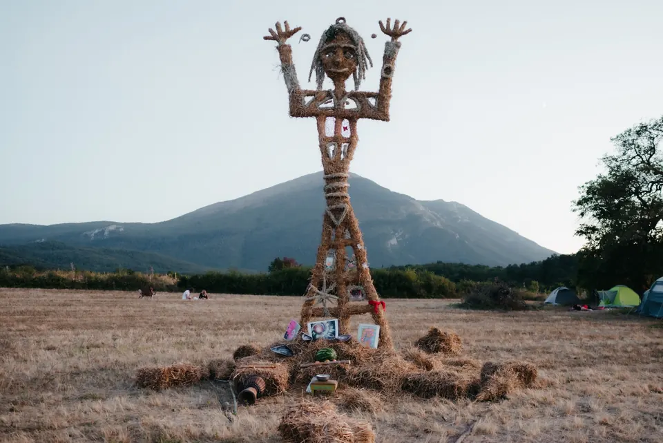 A straw sculpture with Rtanj behind