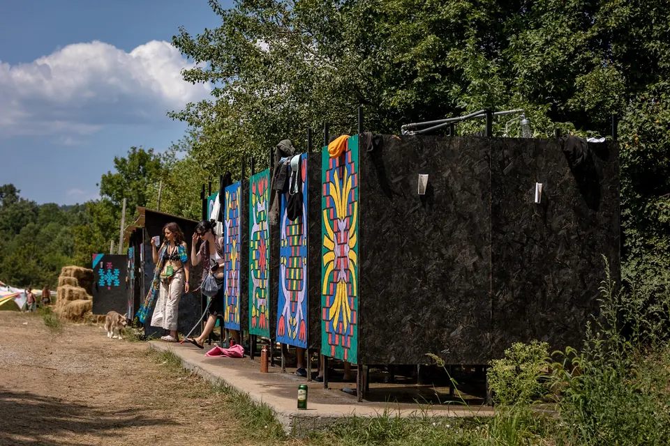 Row of painted shower cabins in the camp
