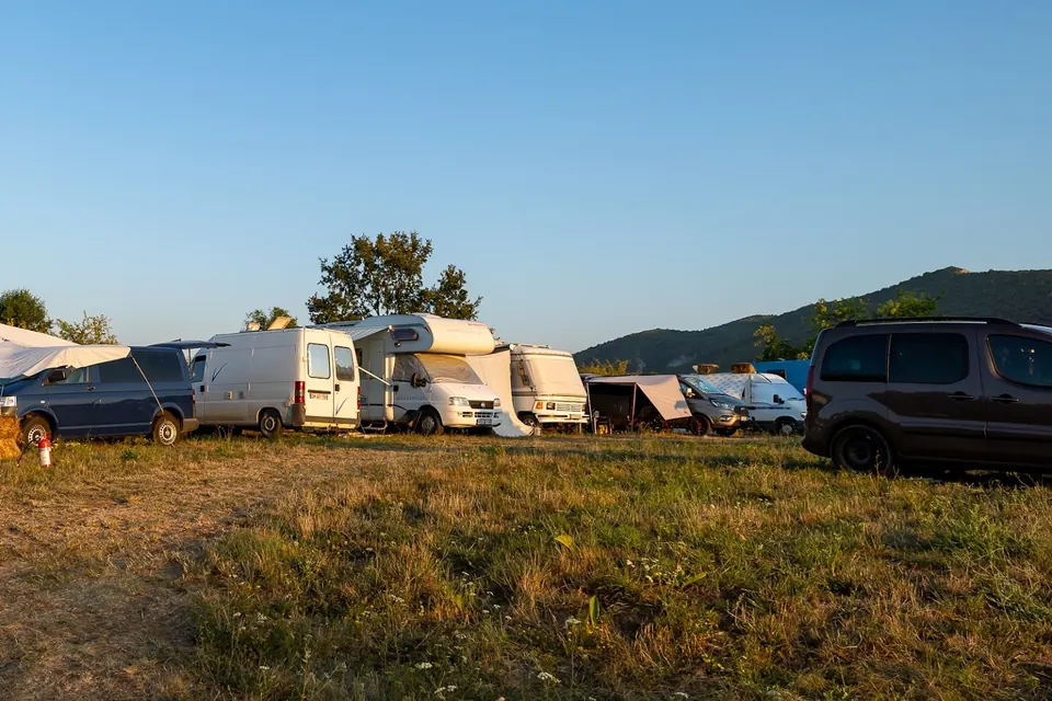 Campervans and motorhomes parked in a row in the camper area