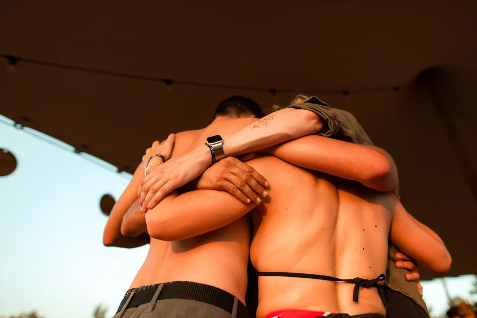 A group hug during Dance of Hearts