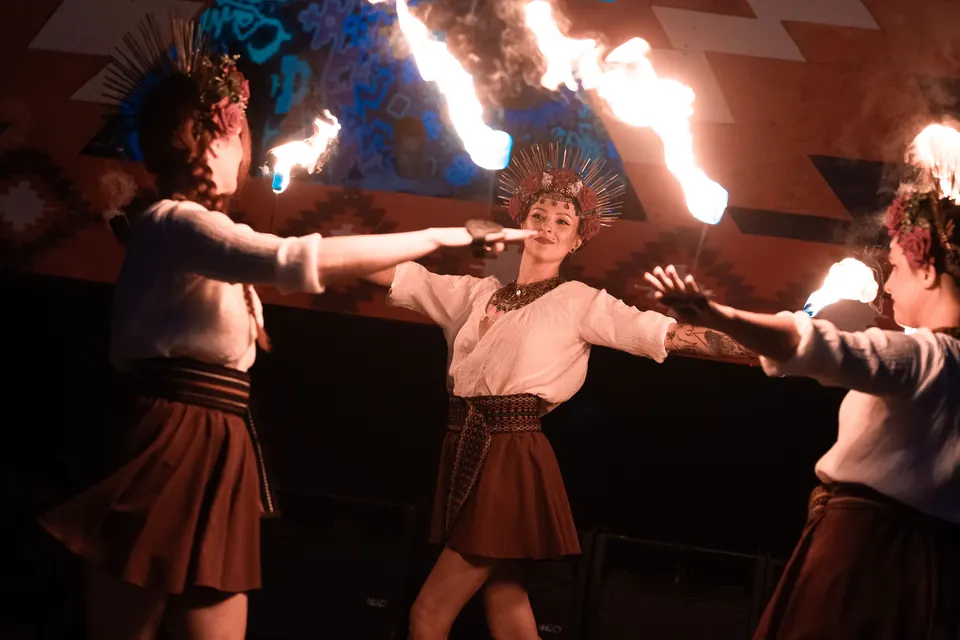 Fire dancers in sun crowns