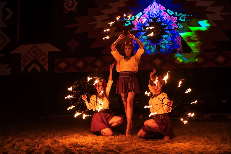 Fire dancers under the glowing mandala