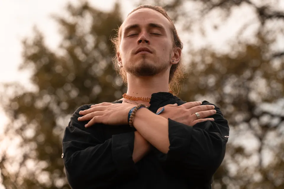 A standing meditation with hands on the chest