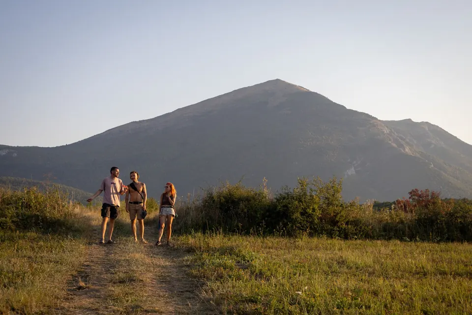 Three friends walk the path towards Rtanj