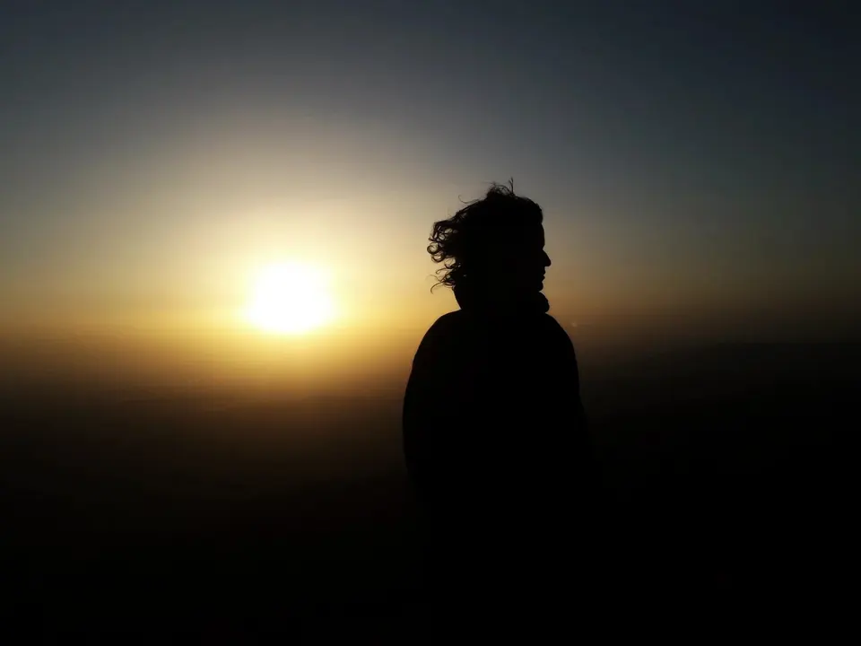 A hiker silhouetted against the sunrise on Rtanj
