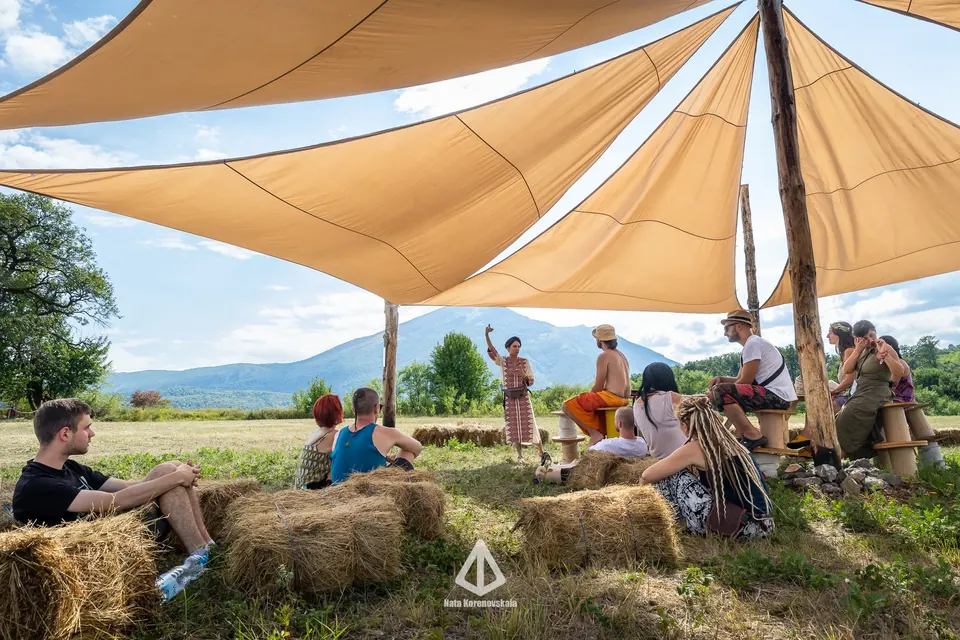 Shade sails and hay bales with Rtanj in the distance