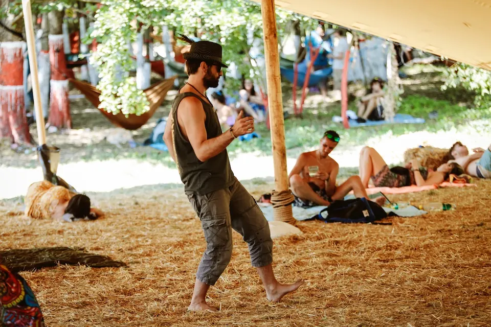 A man dancing barefoot by day at the TOK stage