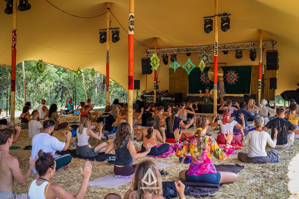 A seated audience in the TOK stage tent
