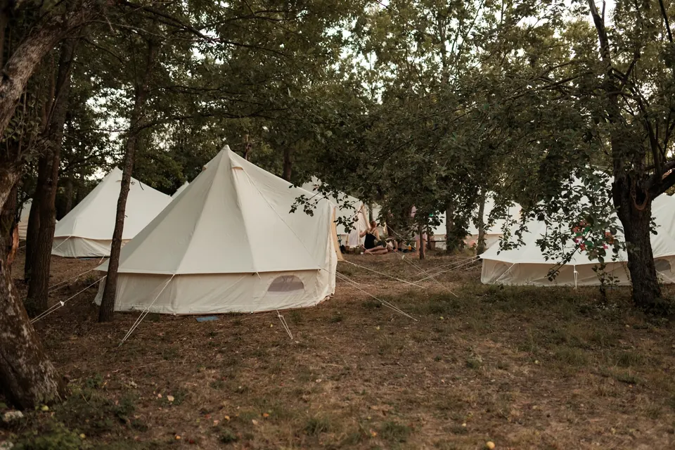 Bell tents under the trees of the village