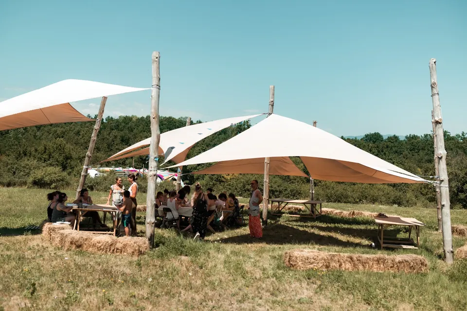 Shade sails and tables on the village meadow