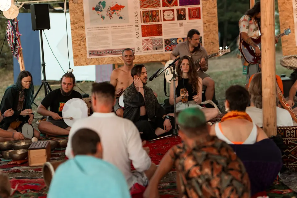 People gathered around guitarists at the VRELO jam in the art zone
